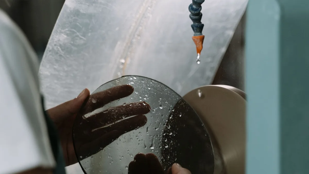 Lente oftálmica sendo cortada em laboratório óptico para óculos de grau